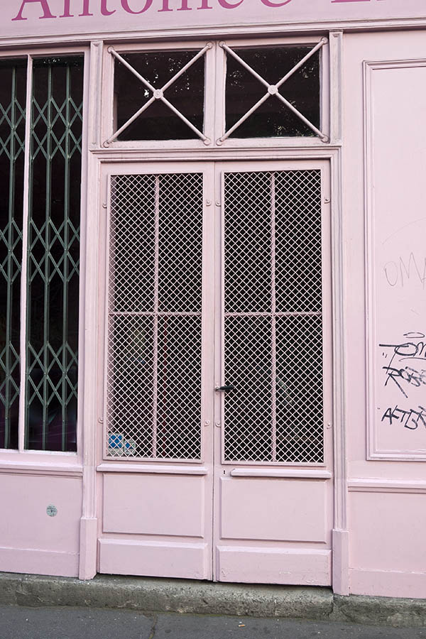 Photo 15529: Panelled, pink double door with large, latticed door lights and barred top windows
