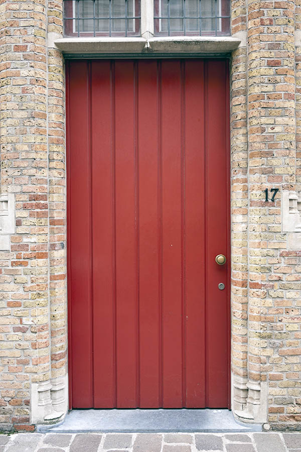Photo 16095: Red door made of planks with a red and white, barred top window
