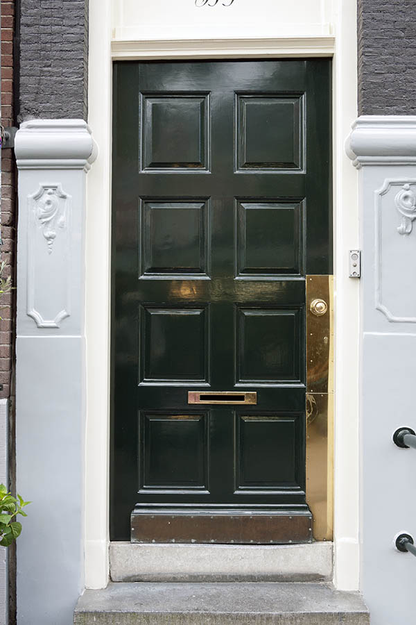 Photo 16156: Panelled, lopsided, black door in a white frame