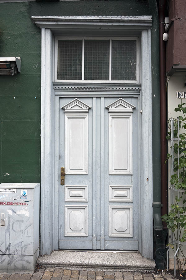 Photo 16182: Worn, wide, lopsided, panelled, light grey and white door with top window