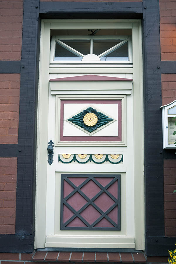 Photo 16204: Panelled, carved, red, green, yellow and white door with top window