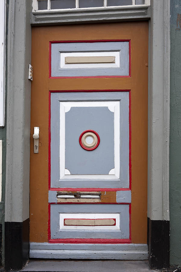 Photo 16215: Worn, panelled, grey, white, red and orange door with white top window