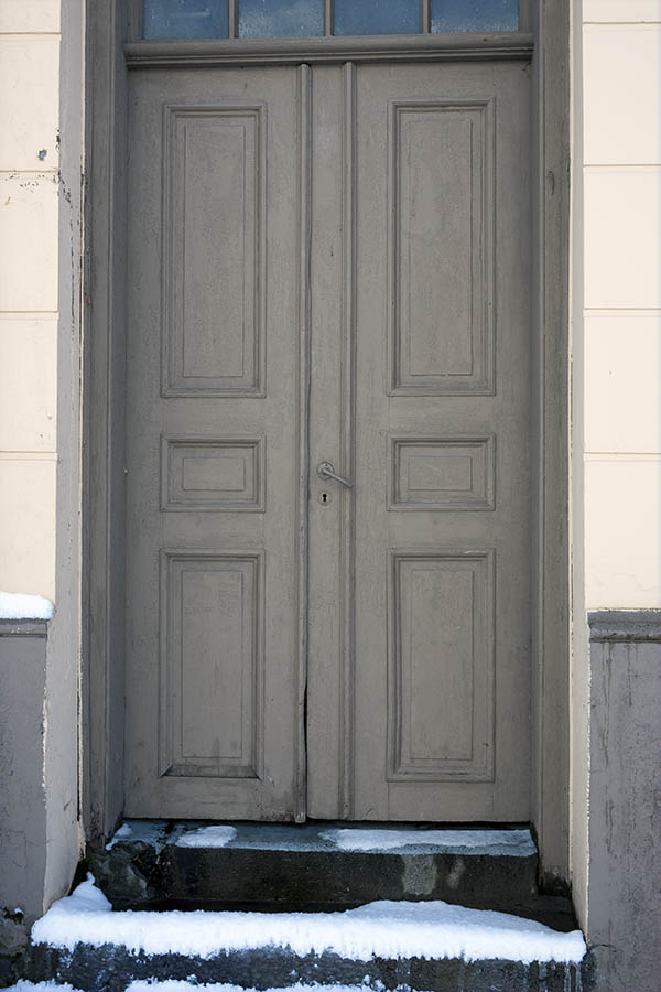 Photo 16997: Worn, panelled, grey double door with top window