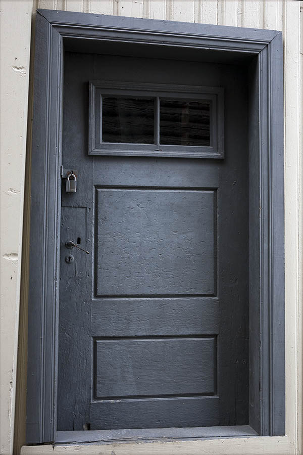 Photo 17347: Worn, panelled, grey door with door light