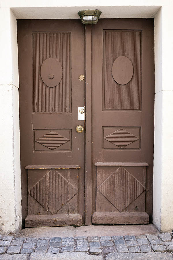 Photo 17877: Lopsided, worn, panelled, brown, carved double door