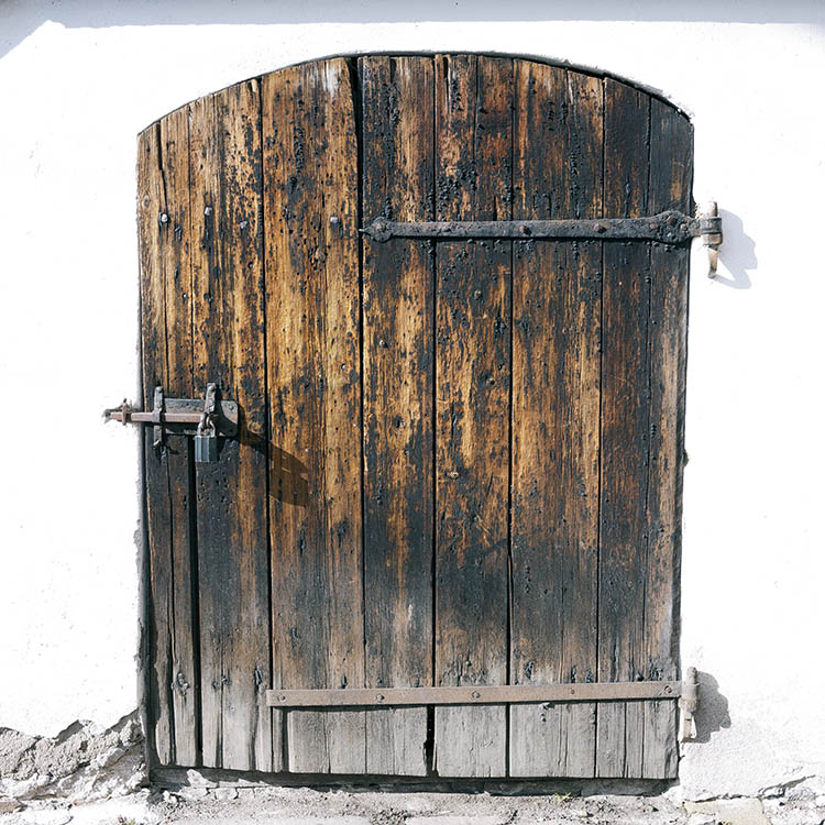 Photo 17969: Decayed, formed, black and unpainted door of boards