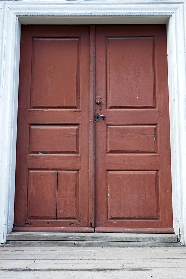 Photo 18065: Worn, panelled, red double door in a white frame