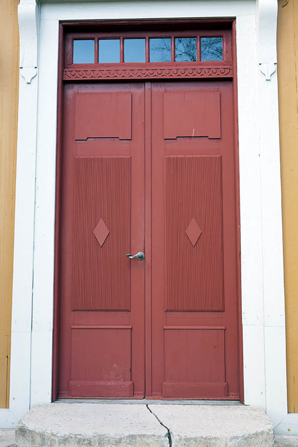 Photo 18105: Panelled, carved, red double door with top window in a white frame