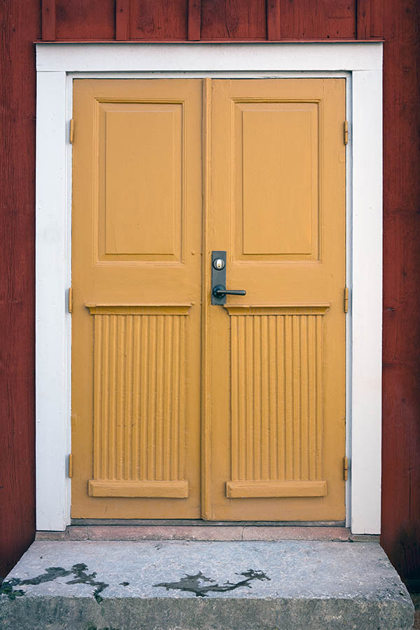 Photo 18234: Panelled, carved, yellow double door in a white frame