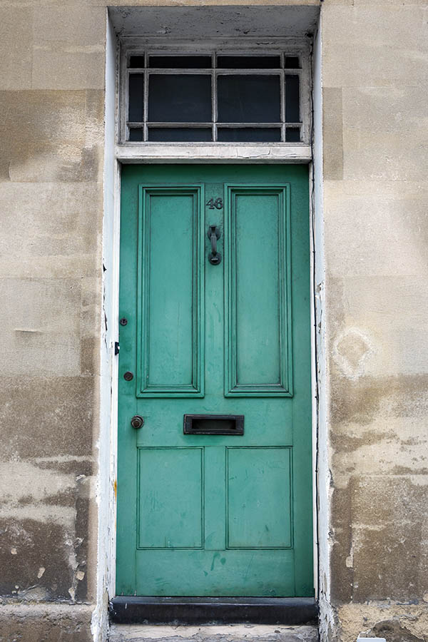 Photo 18760: Worn, panelled, green door with top window in a white frame