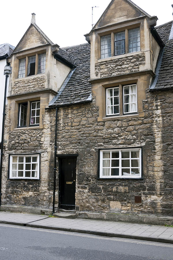 Photo 18825: Facade with a  black door and 12 windows in a black and yellow stone wall