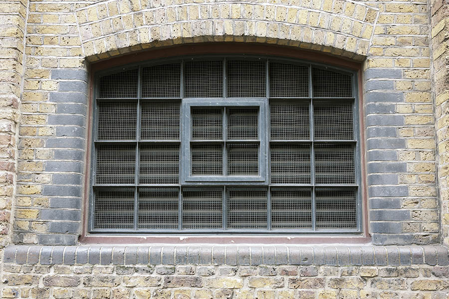 Photo 18906: Formed, latticed, teal and brown window with 24 panes