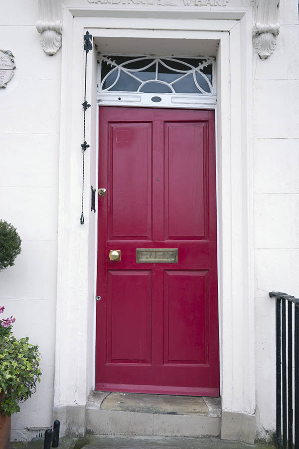 Photo 18918: Lopsided, panelled, cerise red door with a white top window