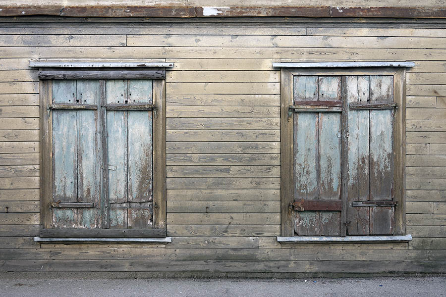 Photo 19767: Two green, shuttered windows in a light brown board partition
