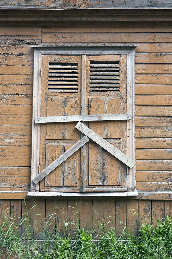 Photo 19779: Decayed, orange and unpainted shutters
