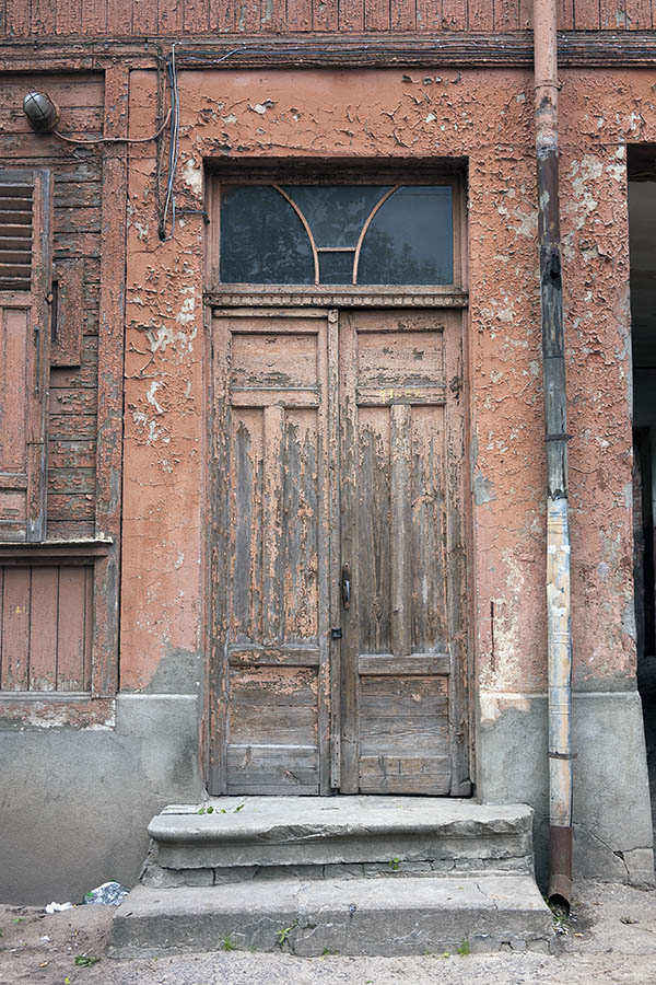 Photo 19785: Narrow, worn, panelled, carved, pink and unpainted double door with top window