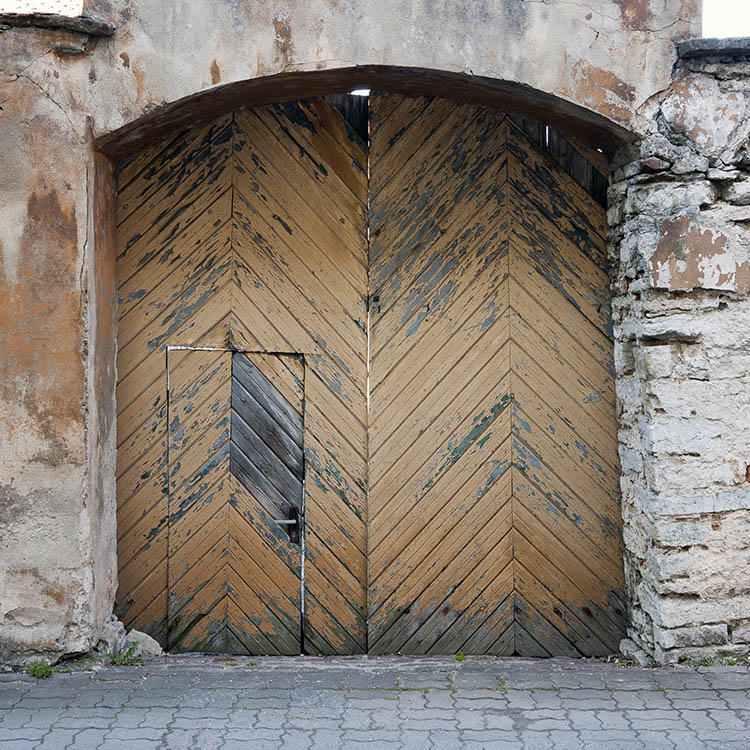 Photo 19858: Decayed, formed, light brown gate of diagonally mounted boards