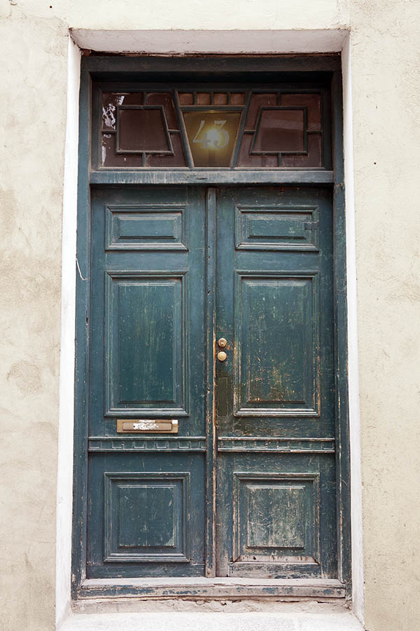 Photo 20172: Worn, panelled, teal double door with top window