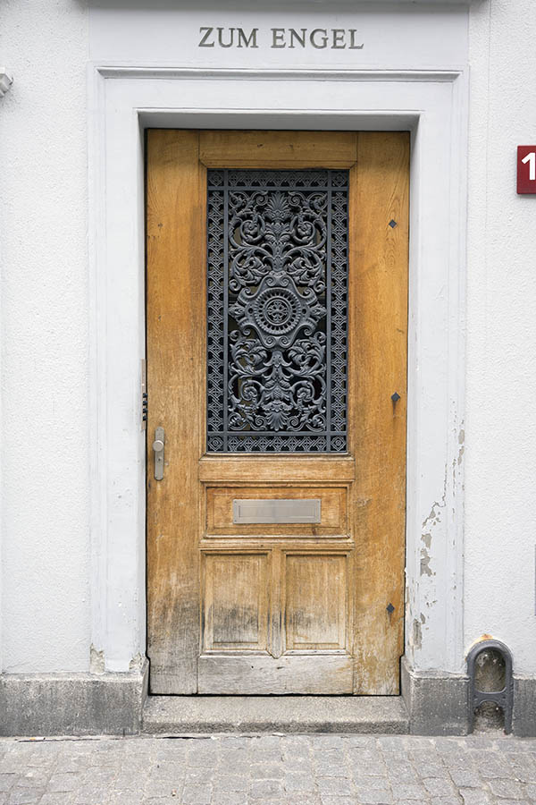 Photo 23849: Worn, unpainted, panelled door with cast-iron lattice