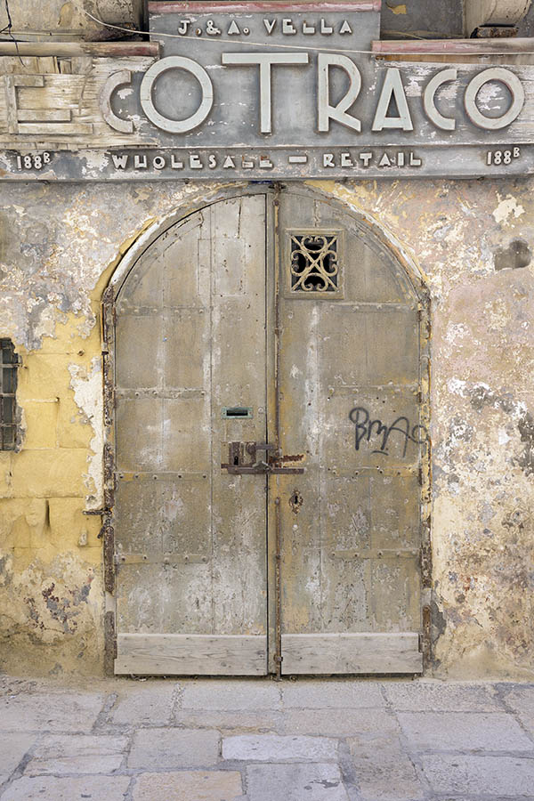 Photo 24086: Worn, formed, grey double door of planks with latticed door light