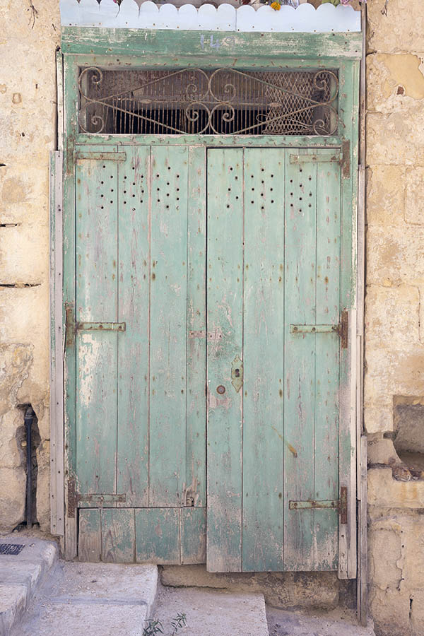 Photo 24091: Decayed, light green door of planks with latticed top window