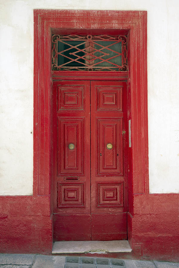 Photo 24111: Worn, panelled, red double door with latticed top window