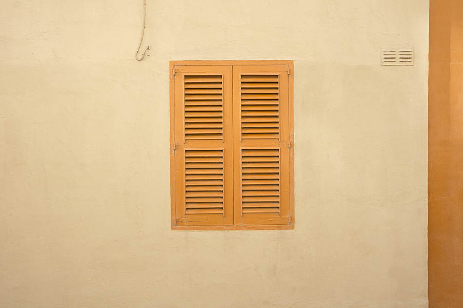 Photo 24255: Yellow-washed facade with an orange, shuttered window
