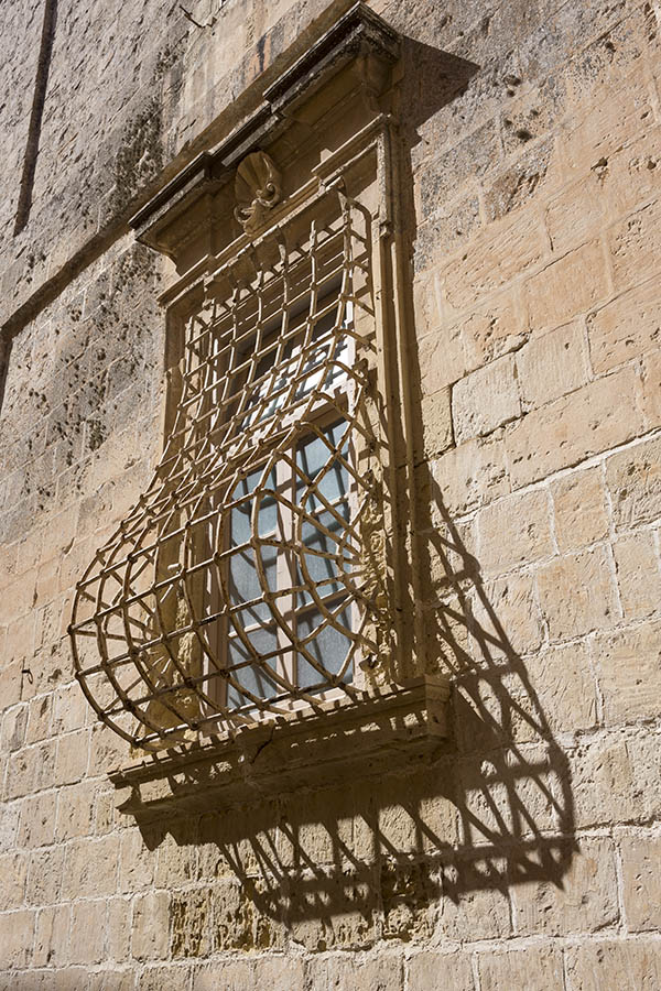 Photo 24271: Large, barred, yellow window with plastered pilaster