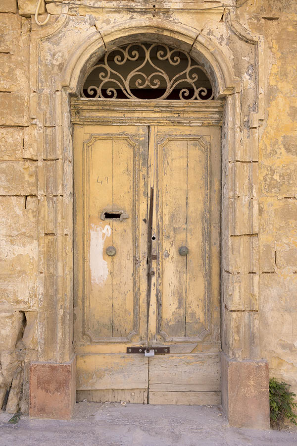 Photo 24289: Decayed, panelled, yellow and unpainted double door with latticed fan light.