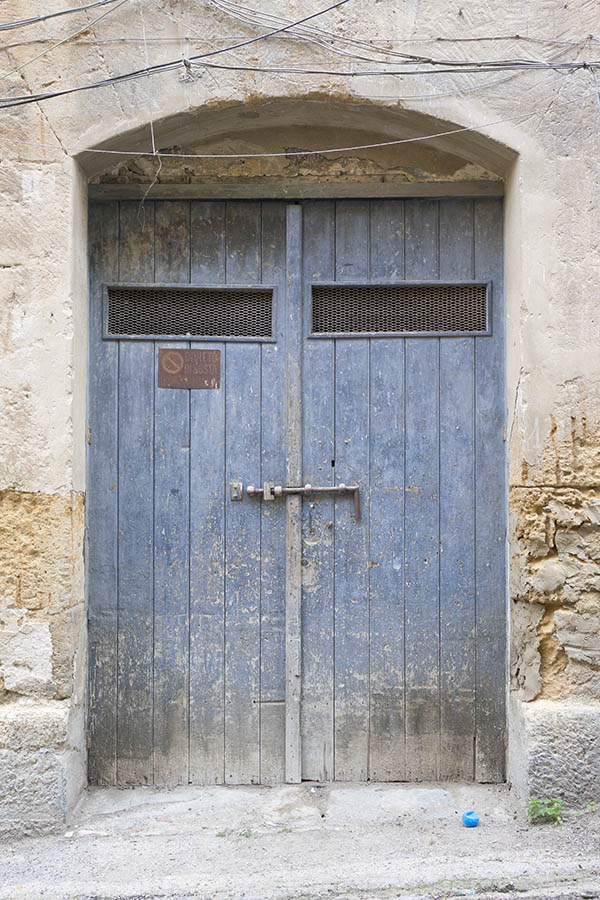 Photo 24454: Worn, blue gate of boards with latticed door lights