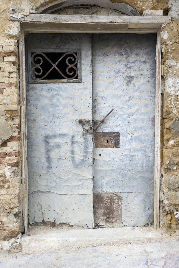 Photo 24458: Decayed, formed, grey metal double door with latticed door light