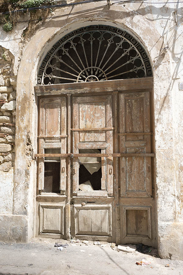 Photo 24576: Decayed, panelled, yellow gate with a large, latticed fan light