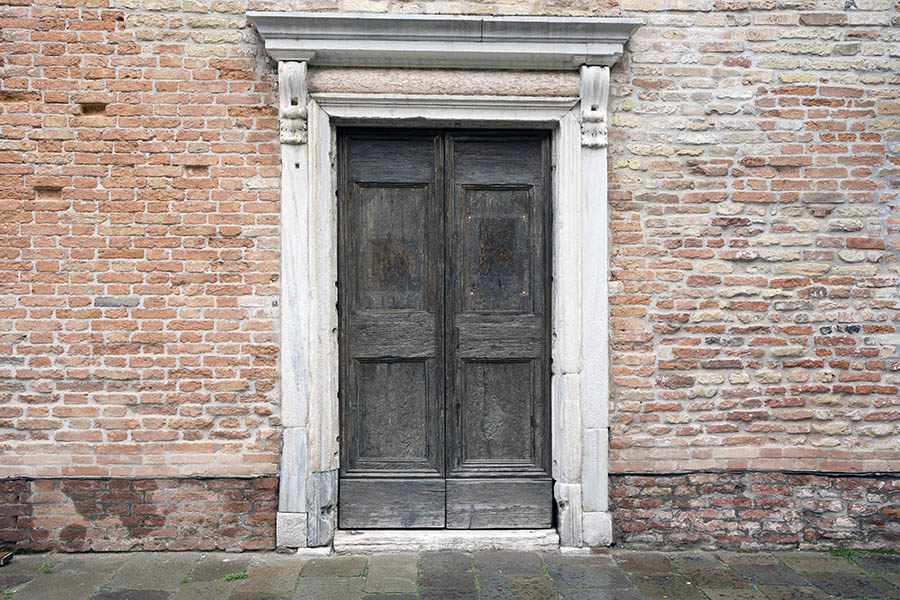 Photo 24795: Facade with worn, panelled, black double door