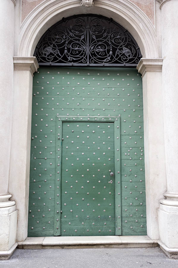 Photo 24975: Green gate of horizontal boards with many nails, minor door and latticed fan light