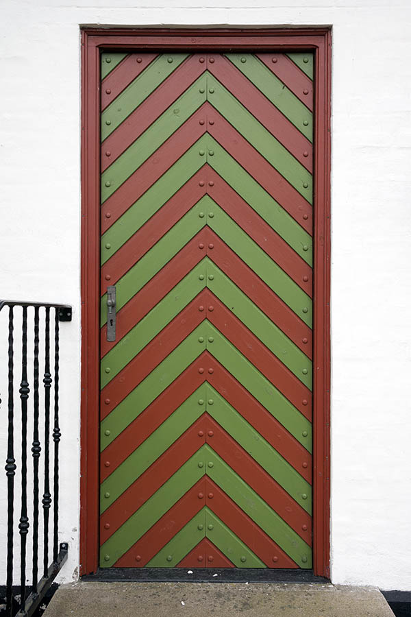 Photo 25078: Red and green door of diagonally mounted boards with nails