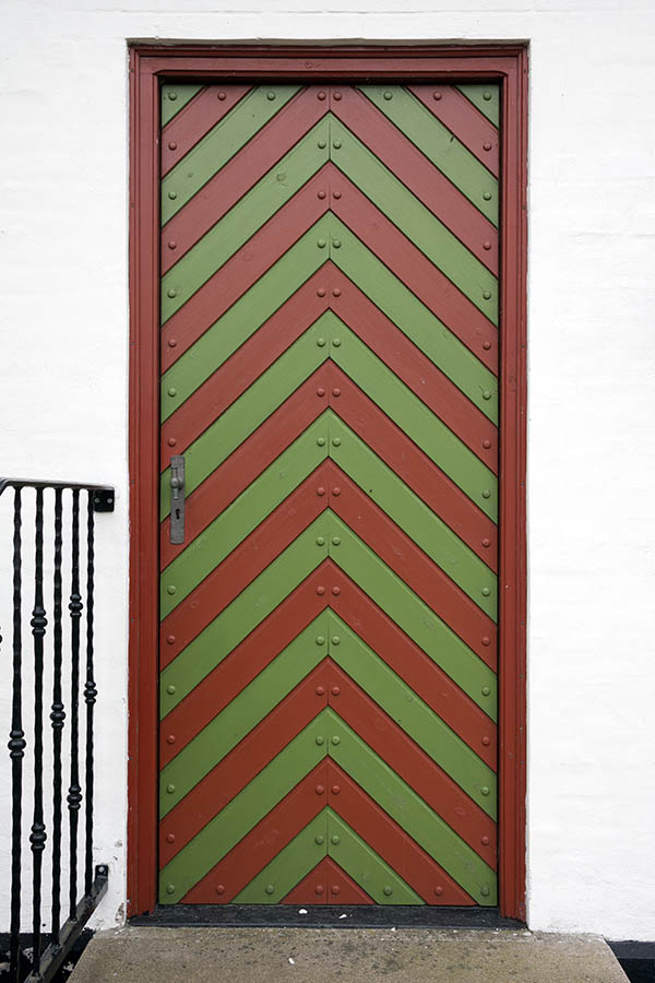 Photo 25078: Red and green door of diagonally mounted boards with nails