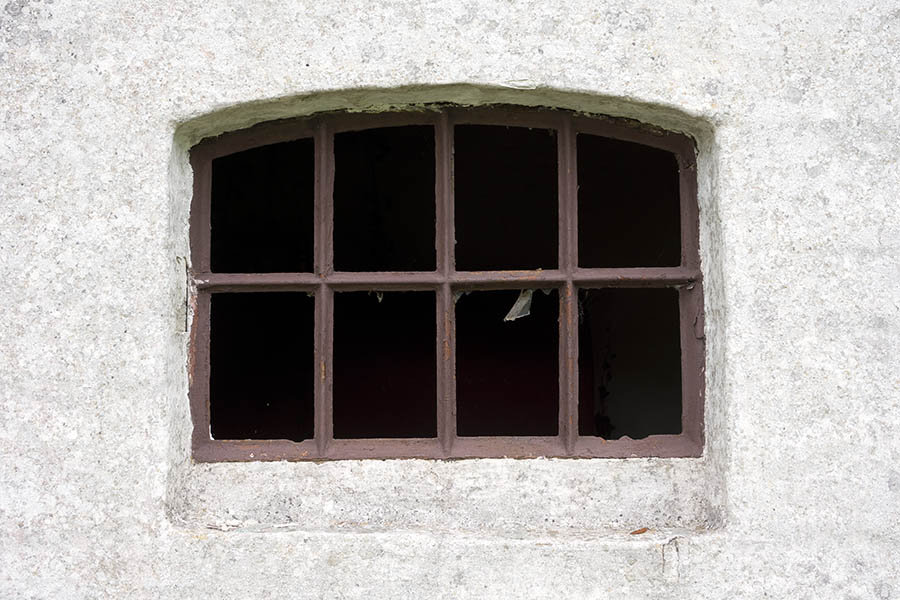 Photo 25151: Formed, rusty, brown metal window with eight panes without glass