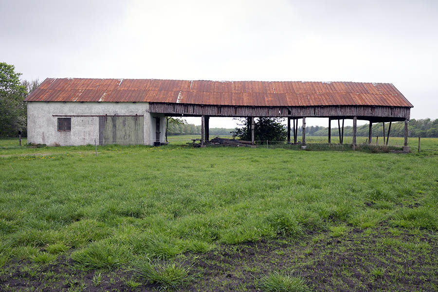 Photo 25175: Facade of white stable and barn with rusty, brown metal roof