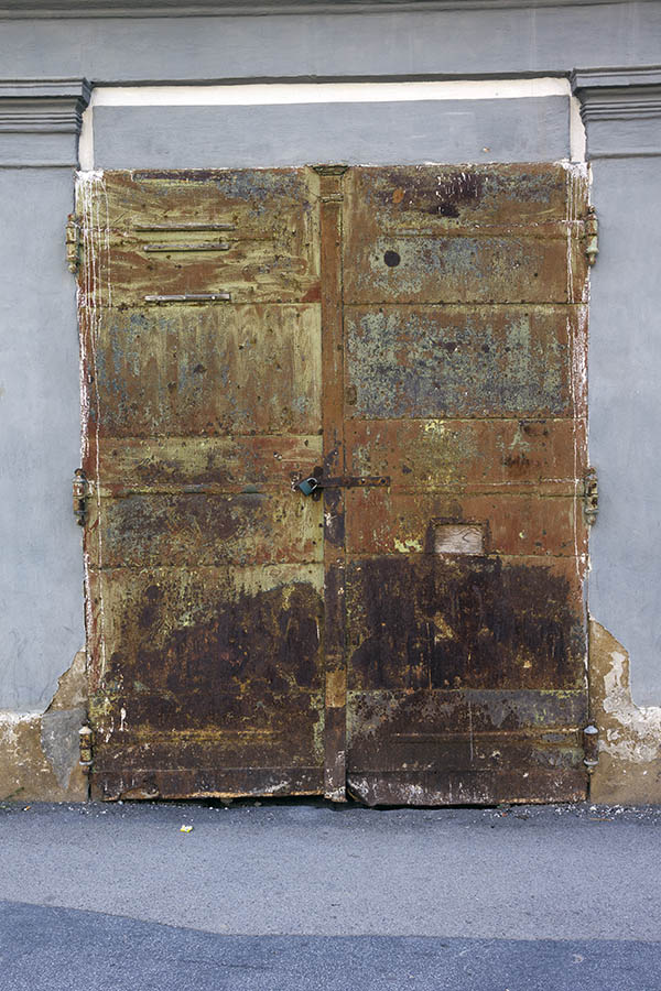 Photo 25351: Worn, brown, unpainted gate of metal plates