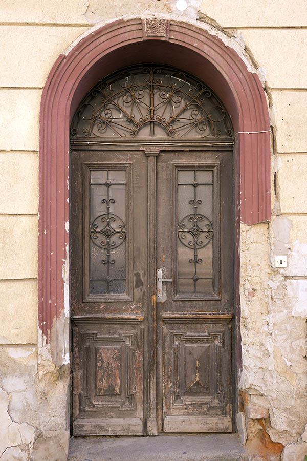 Photo 25358: Decayed, panelled, carved, brown and unpainted double door with latticed door lights and fan light
