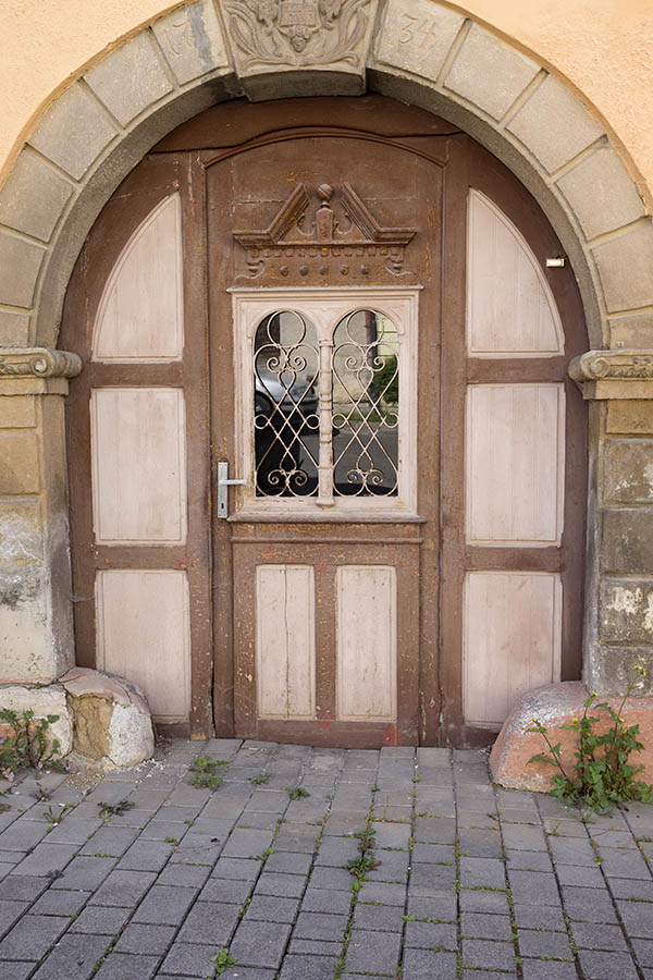 Photo 25380: Worn, formed, panelled, carved, brown and light brown door with latticed door light