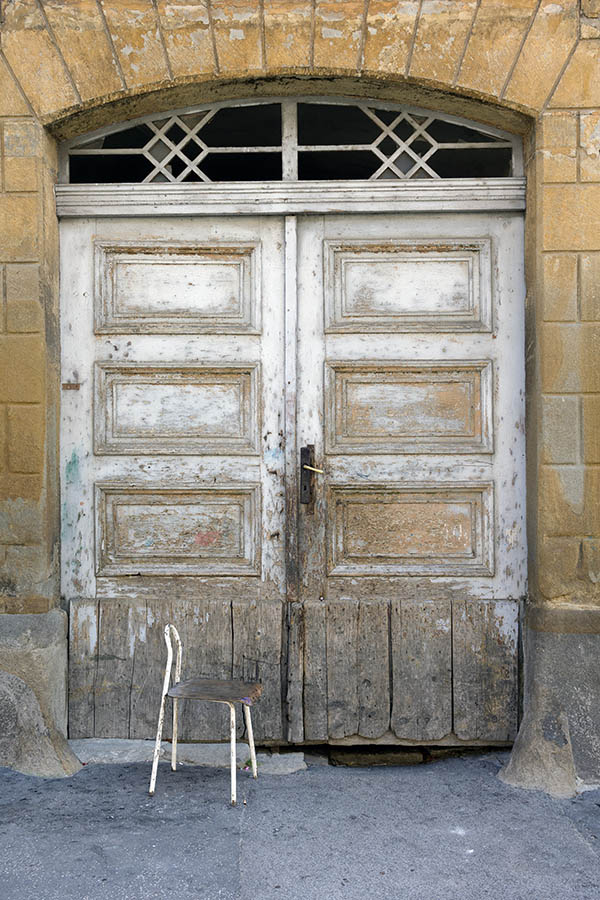 Photo 25483: Decayed, panelled, white and unpainted gate with fan light