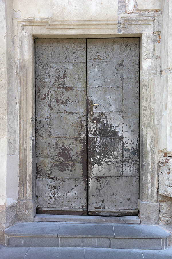 Photo 25506: Worn, grey and brown double door covered with metal plates