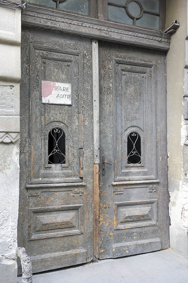 Photo 25538: Worn, panelled, grey and unpainted gate with formed, latticed door lights and top window