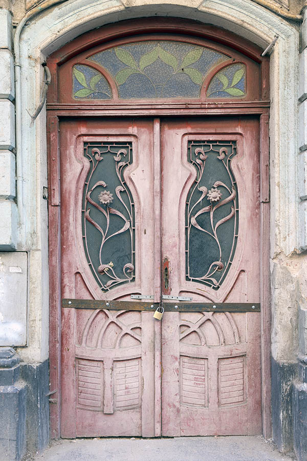 Photo 25554: Worn, panelled, formed, pink double door with latticed door lights and fan light