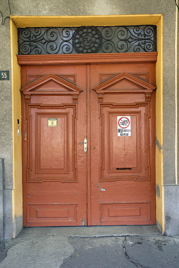 Photo 25692: Panelled, carved, orange and yellow gate with latticed top window