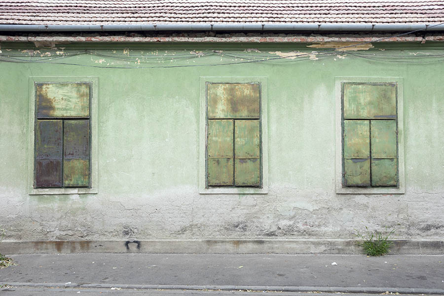 Photo 25757: Worn, light green facade with three blocked windows