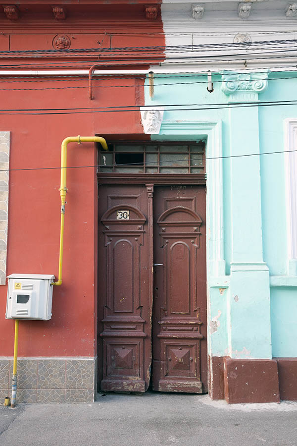 Photo 25840: Facade with narrow, panelled, carved, brown double door