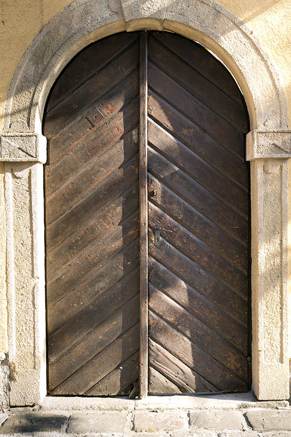 Photo 25968: Worn, formed, brown double door of diagonal boards