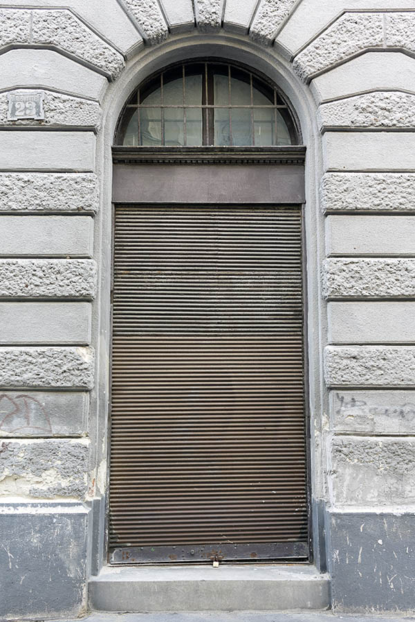 Photo 26022: Door with brown security shutter and barred fan light